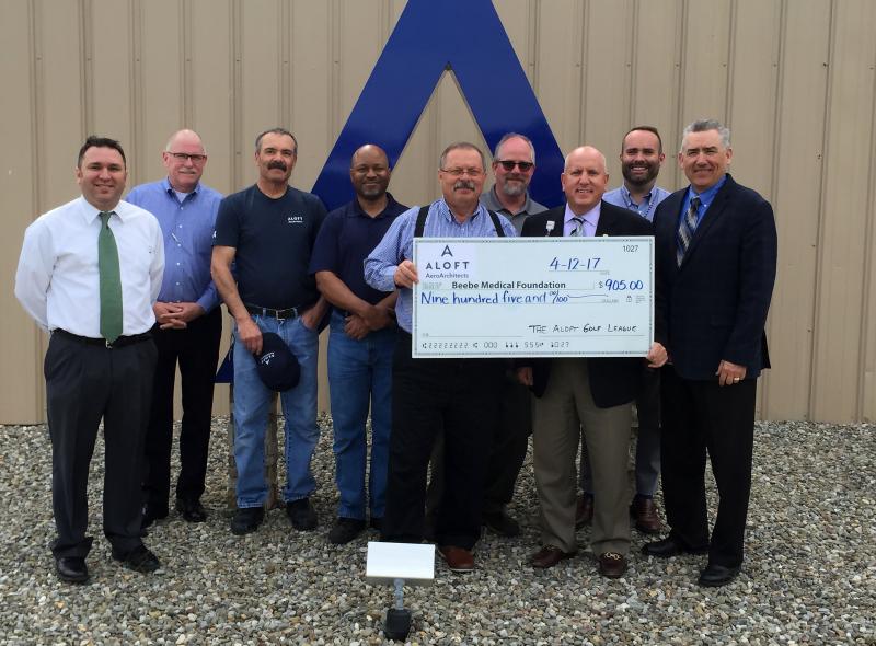 Shown are (l-r) ALOFT team members Bryan Ochs, Mark Ryan, Van Johnson, Erik Lester, Joe Reinhardt and Shawn Appleby; Tom Protack, vice president of development for Beebe Medical Foundation; Robert Sundin, president and CEO of ALOFT; and Matt Hill. Additional ALOFT team members were unavailable for the photo. SUBMITTED PHOTO